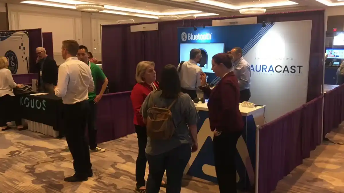 The Auracast booth at HLAA provided attendees a chance to try out the new technology.