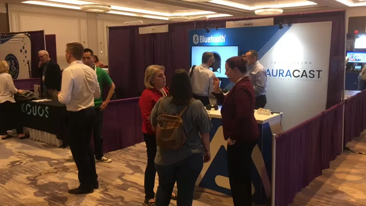 The Auracast booth at HLAA provided attendees a chance to try out the new technology.