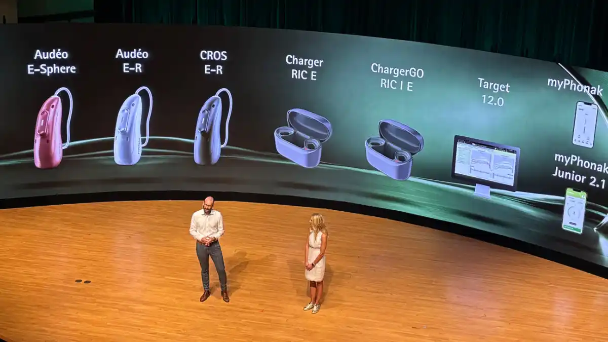 Phonak's Michael Preuss and Christine Jones present the new EON hearing aid product line at Chicago's Rivinia festival auditorium.