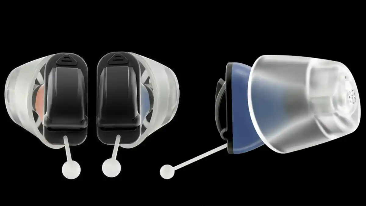 The extremely small Rexton M-CORE iX hearing aids, two models viewed from the back and one from the side.