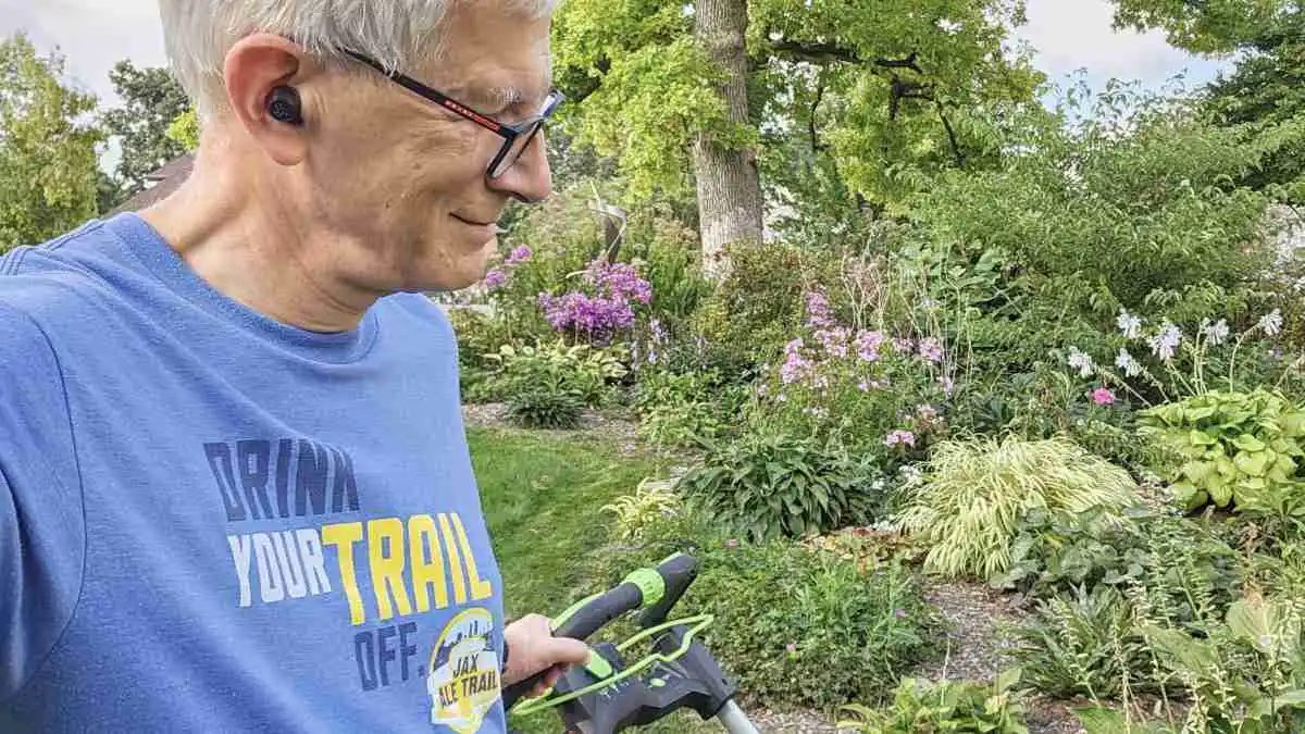 Hearing care expert Andrew Bellavia, who wears hearing aids for his severe hearing loss, is shown here wearing noise-cancelling earbuds with personalization for listening to music.