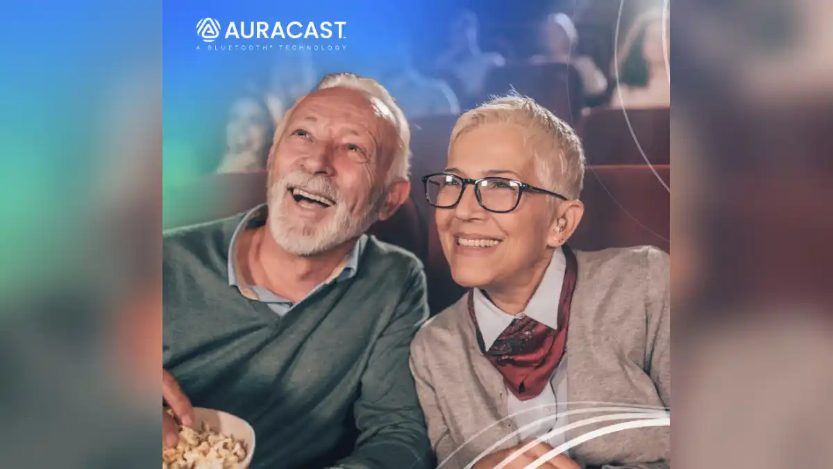 Two people enjoying Auracast in a movie theatre