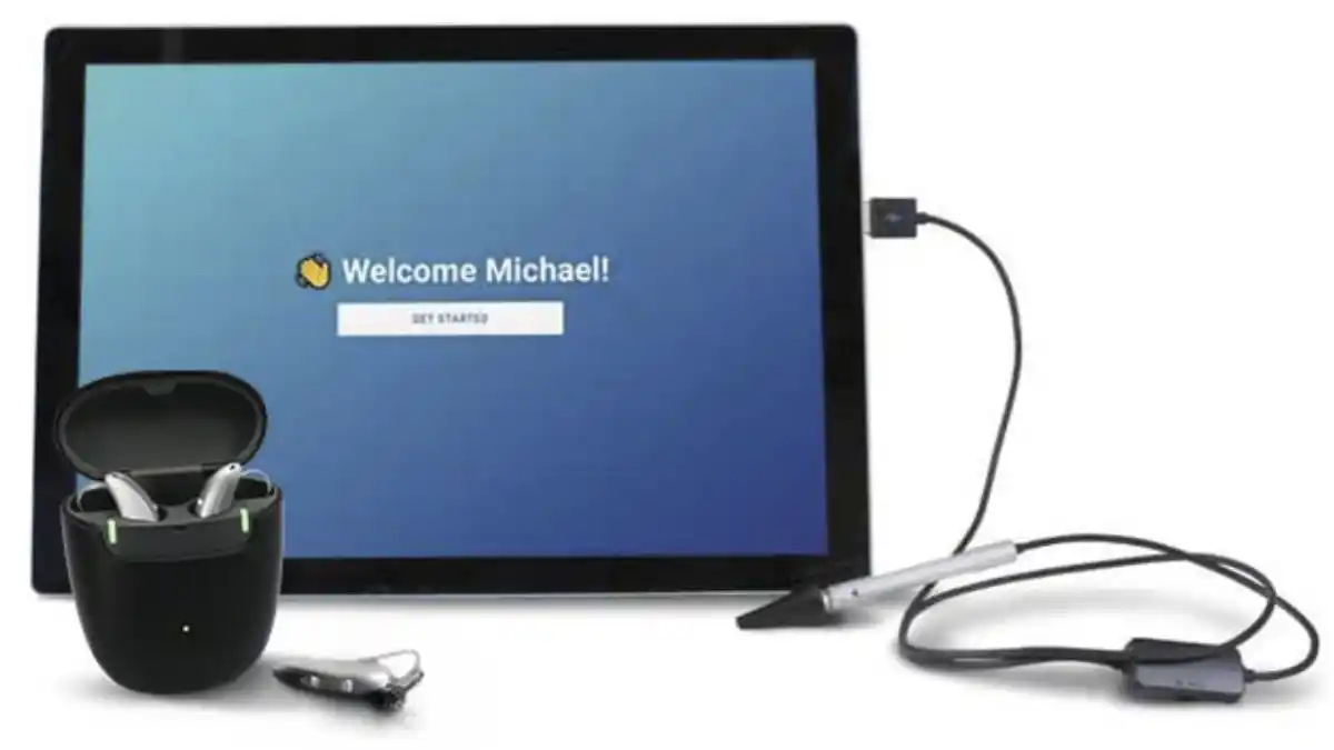 A table connected to an otoscope that says "Welcome Michael" and a set of hearing aids