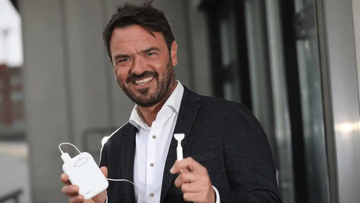 Neuromod CEO Dr. Ross O'Neill with Lenire Tinnitus Treatment Device.