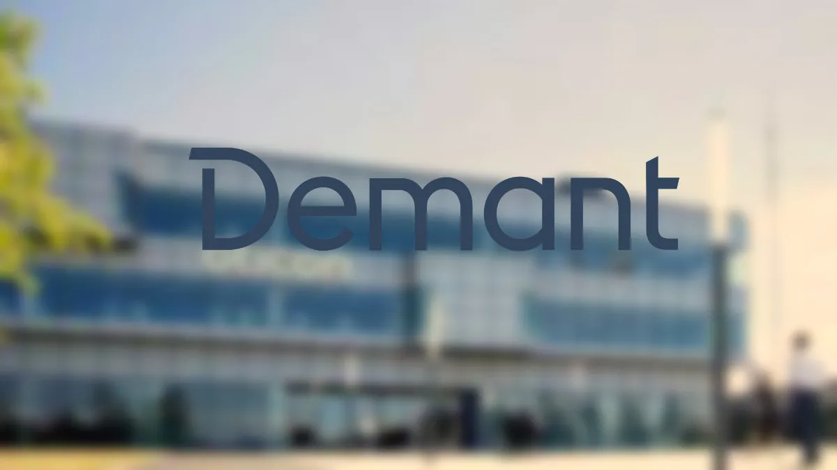 Blurred Oticon headquarters with Demant logo
