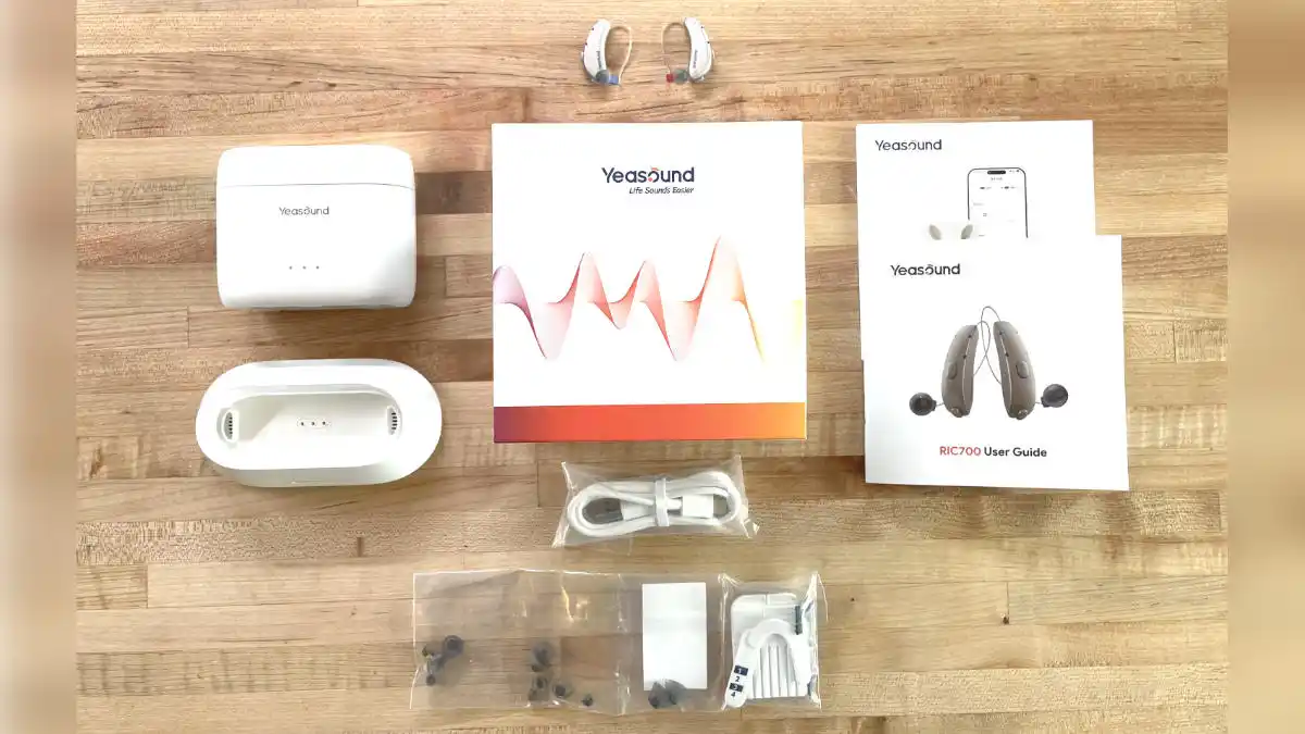Contents of the Yeasound RIC700 box include the hearing aids, recharger and base, USB-C cable, instructions, different-sized ear domes, and cleaning tools.