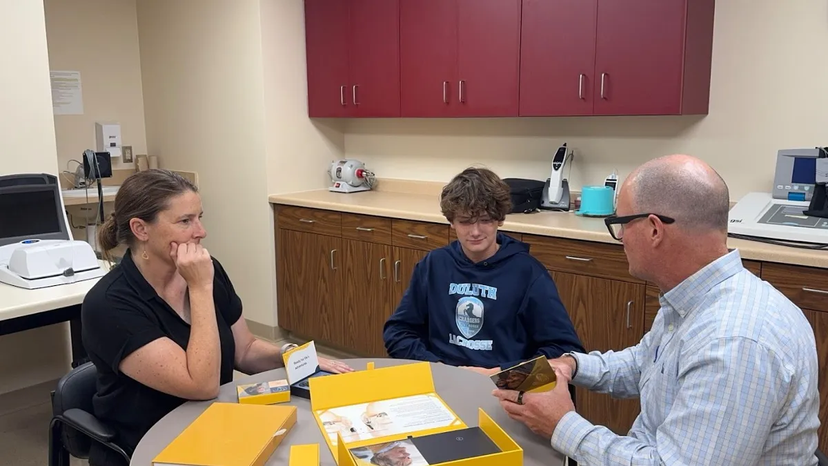 Audiologist counseling patients on hearing aid use