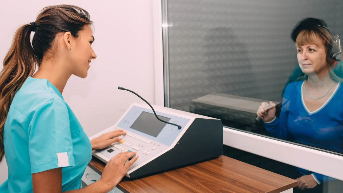 Audiometric testing in a sound booth usually involves some form of, "Please press the button or raise your hand when you hear the tone..." It will also measure your speech understanding, bone-conduction hearing, and other important measures like hearing in noise. 
