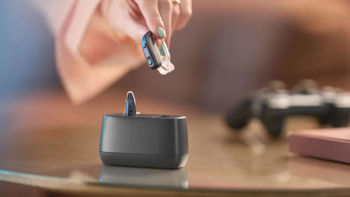 ReSound Enzo IA and desktop charger.