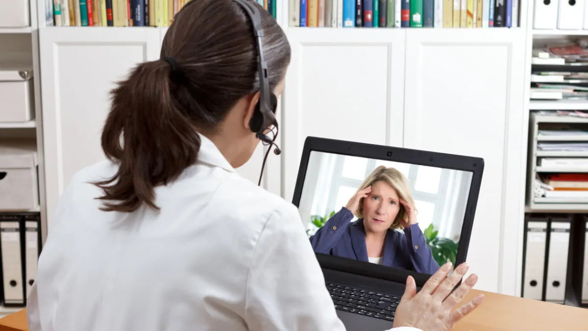 Patient talking with a hearing care provider via telecare