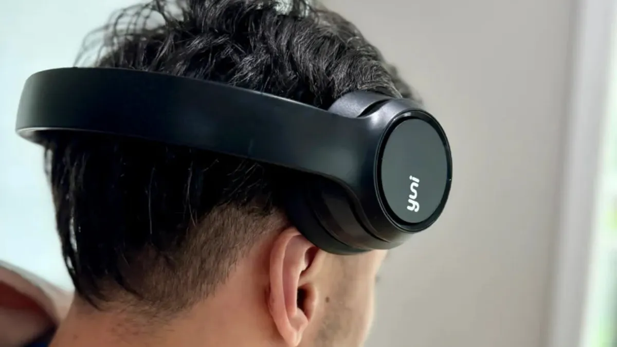 Yuni headphone off of ear and resting on man's temple