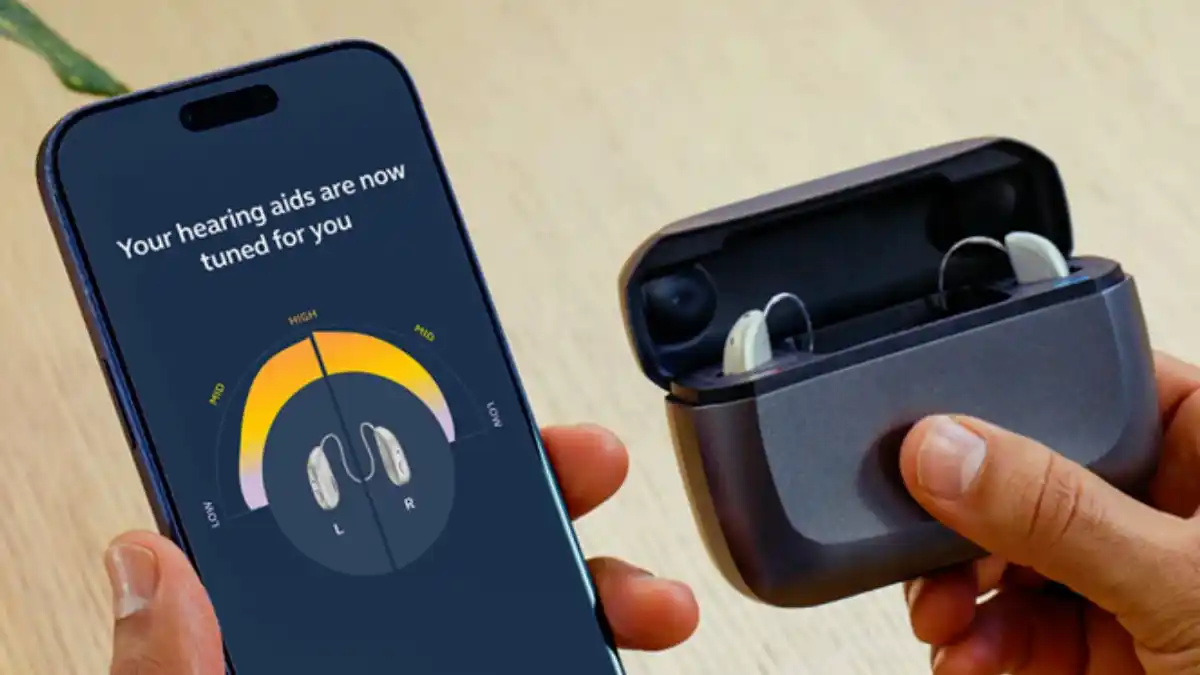 Photo of hearing aids and charger next to app-based test on smartphone