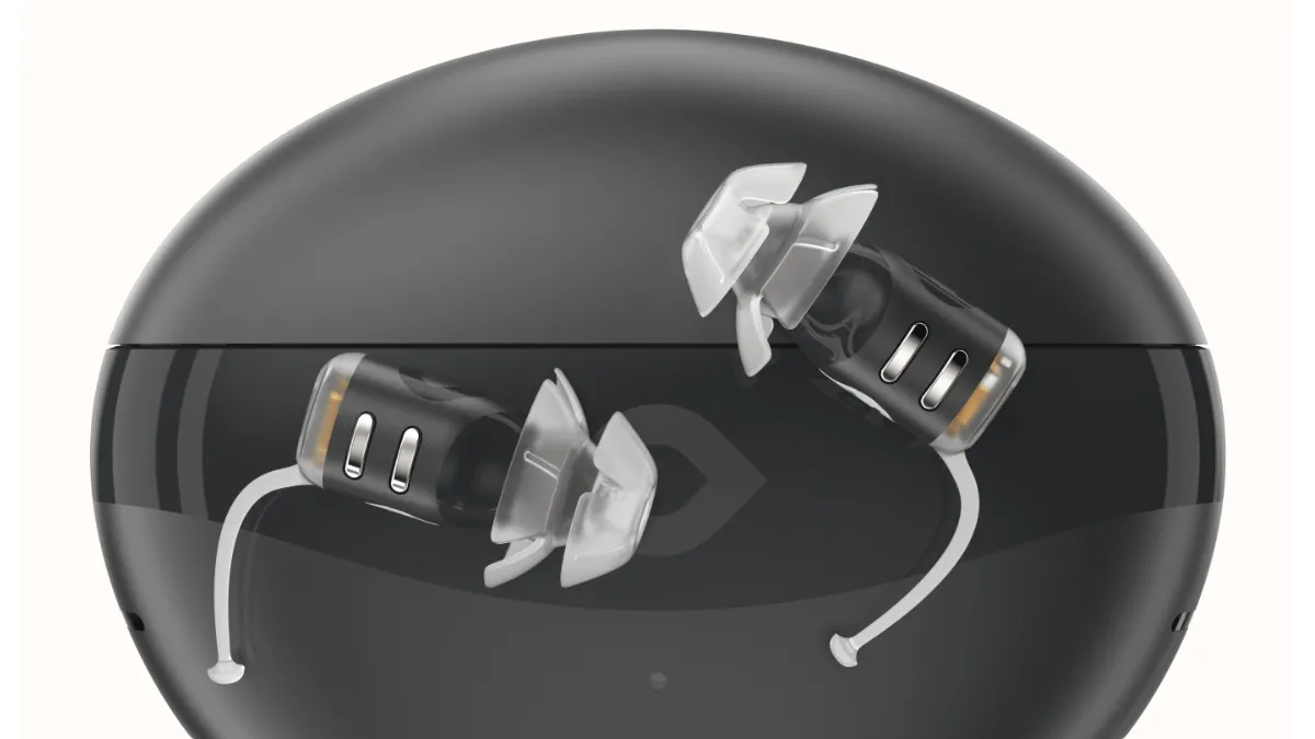 Eargo SE on top of portable charging case that carries up to five extra charges.