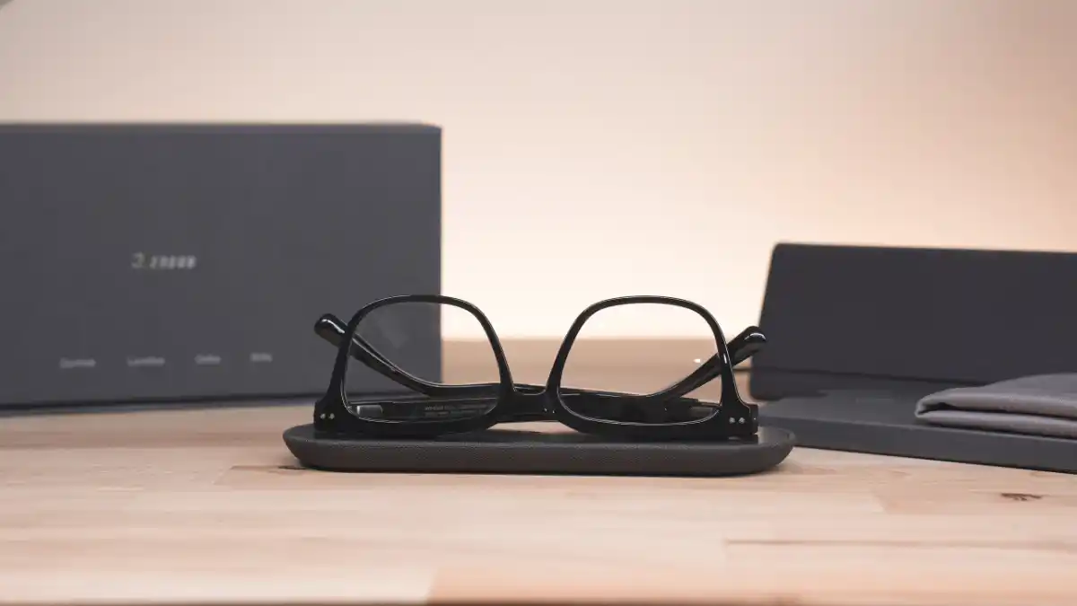 Nuance Audio Glasses on charging pad. The LED light indicates the charging status, with green indicating a full charge.