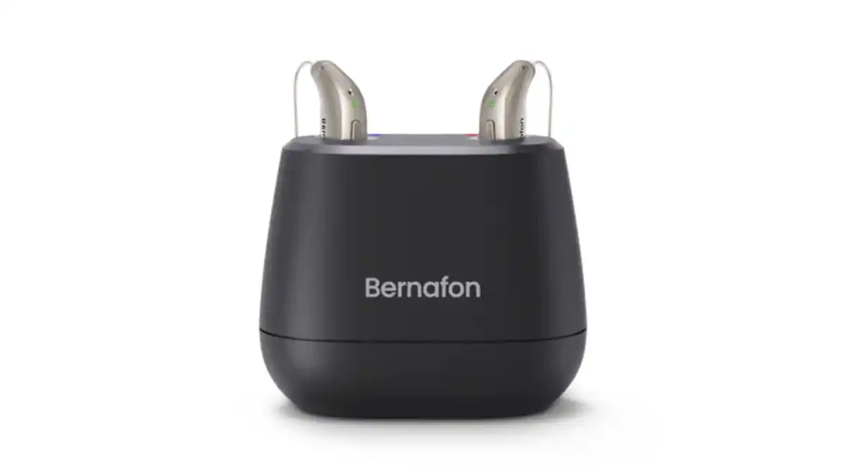 Black Bernafon desktop charger with two Encanta aids inserted