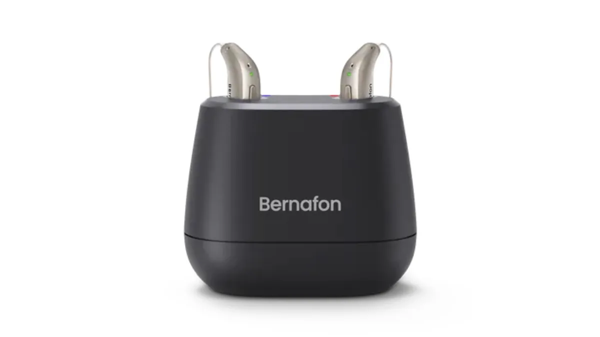 Black Bernafon desktop charger with two Encanta aids inserted