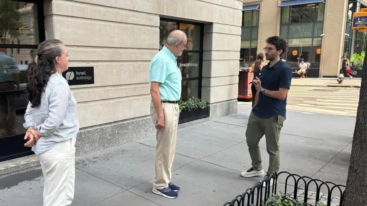 In this photo, I'm testing the Fortell AI 2.0 hearing aids on Park Avenue, with Fortell CEO Matthew de Jonge speaking in front of me and Audiologist Kathleen Wallace speaking behind me.