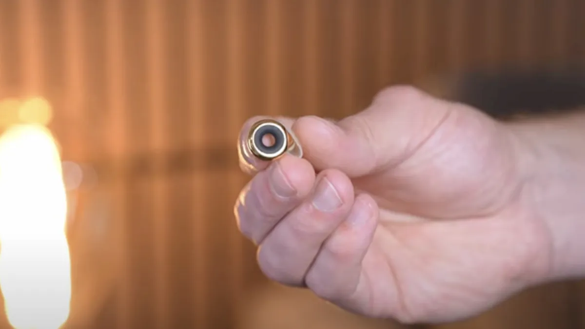 Gold-color Loop Experience 2 with black mute ring in hand
