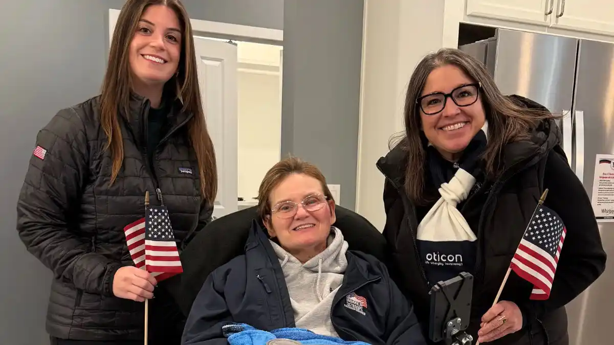 MAJ Dolly Harris (center) with Oticon's Kristin Billich and Sarah Draplin.
