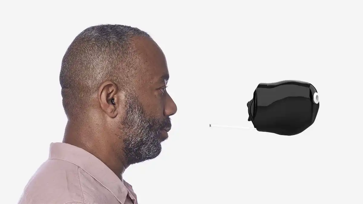 Side photo of man wearing tiny IIC aid with close-up of IIC 