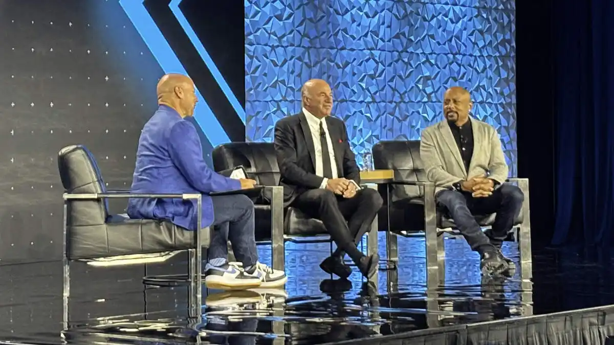 Brandon Sawalich chats onstage with Shark Tank's Kevin O'Leary and Daymond John, who both wear Starkey hearing aids.