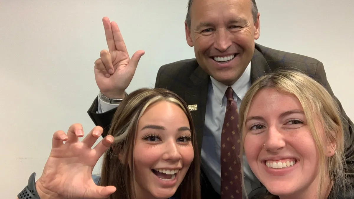 Counter-clockwise from right is the author, a CDIS classmate, and Texas State University President Dr. Kelly Damphousse.