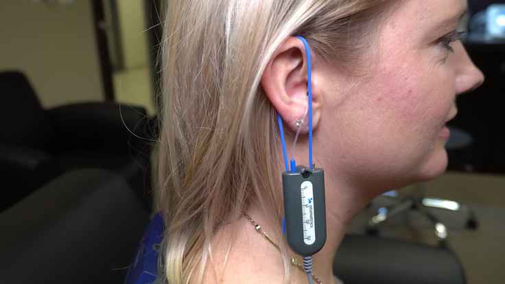 Photo of woman with probe microphone in ear