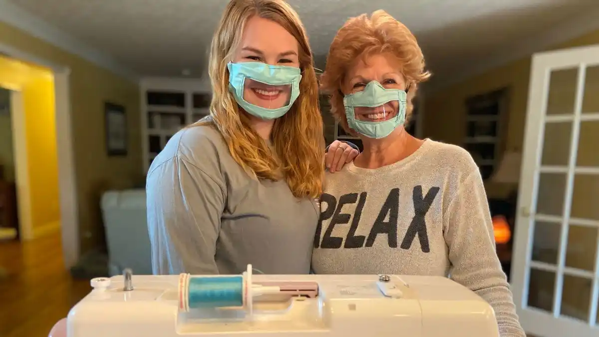 Ashley Lawrence (left) and her mother made their first batch of hearing-loss accessible masks out of bed sheets. Original image via LEX18.