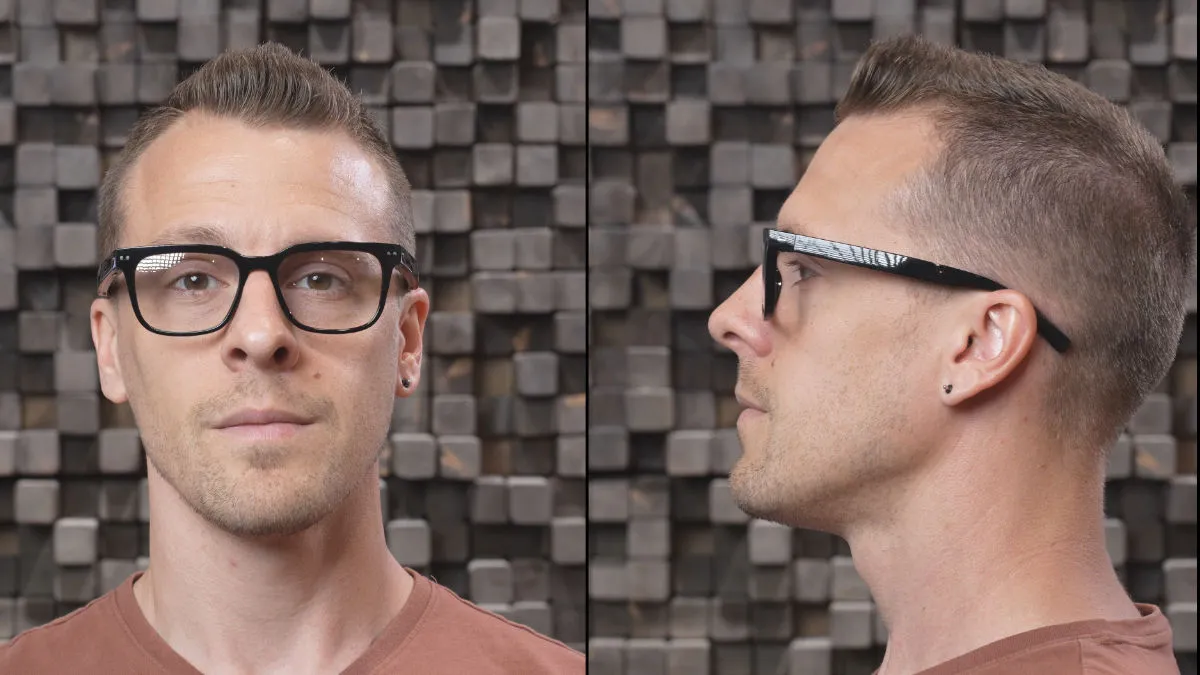 The author testing the comfort and sound quality of Nuance Audio Hearing Glasses. (Note that the white highlights in this photo are reflections from the HearAdvisor lab's lights and not part of the glasses' design).