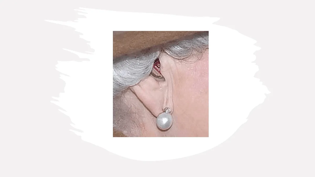 Close up of Queen Elizabeth II's Silk hearing aid which was not inserted optimally (ie, the brown faceplate of the aid where the microphone is located should be oriented more outwardly, and not toward the bowl of her ear).