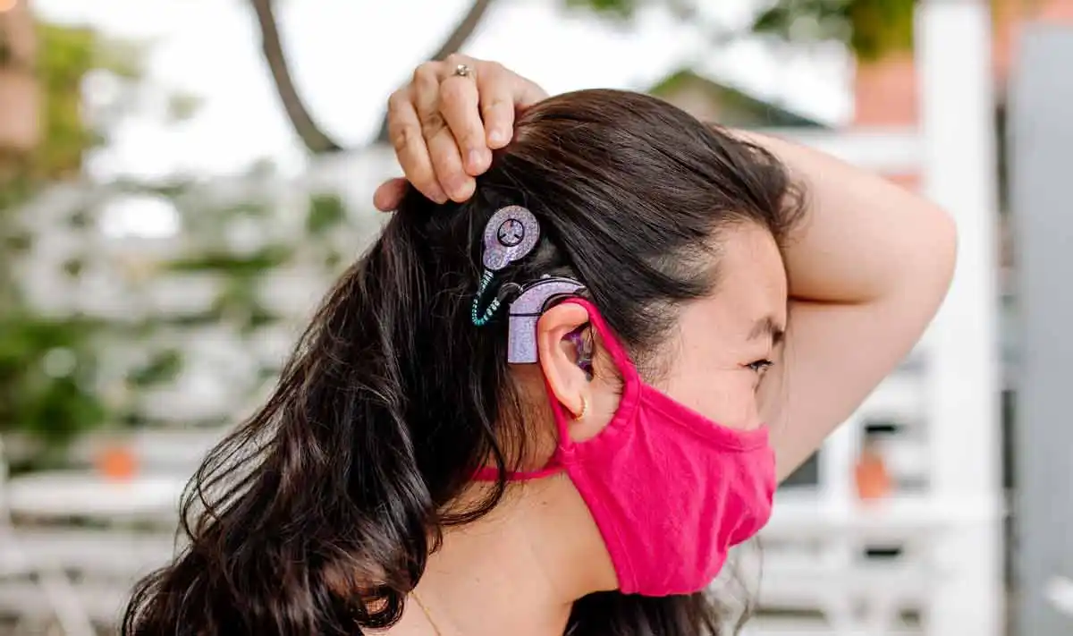 Dr. Hu shows off her sparkly pink cochlear implant. 