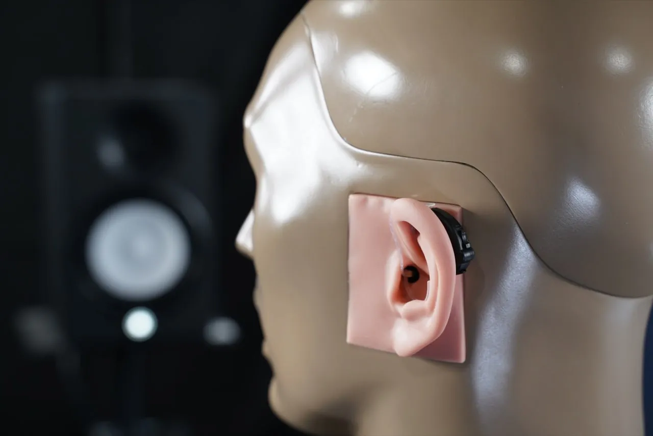 Lucid Engage on KEMAR. The multi-function rocker switch can be seen towards the back of the device.