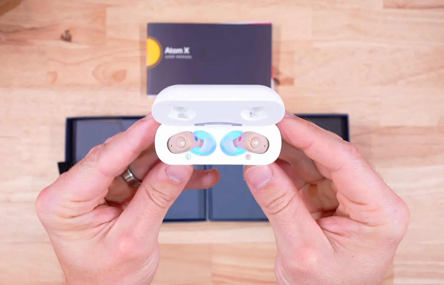 A blue light can be seen under the hearing aids thanks to the built-in ultraviolet light cleaning system.
