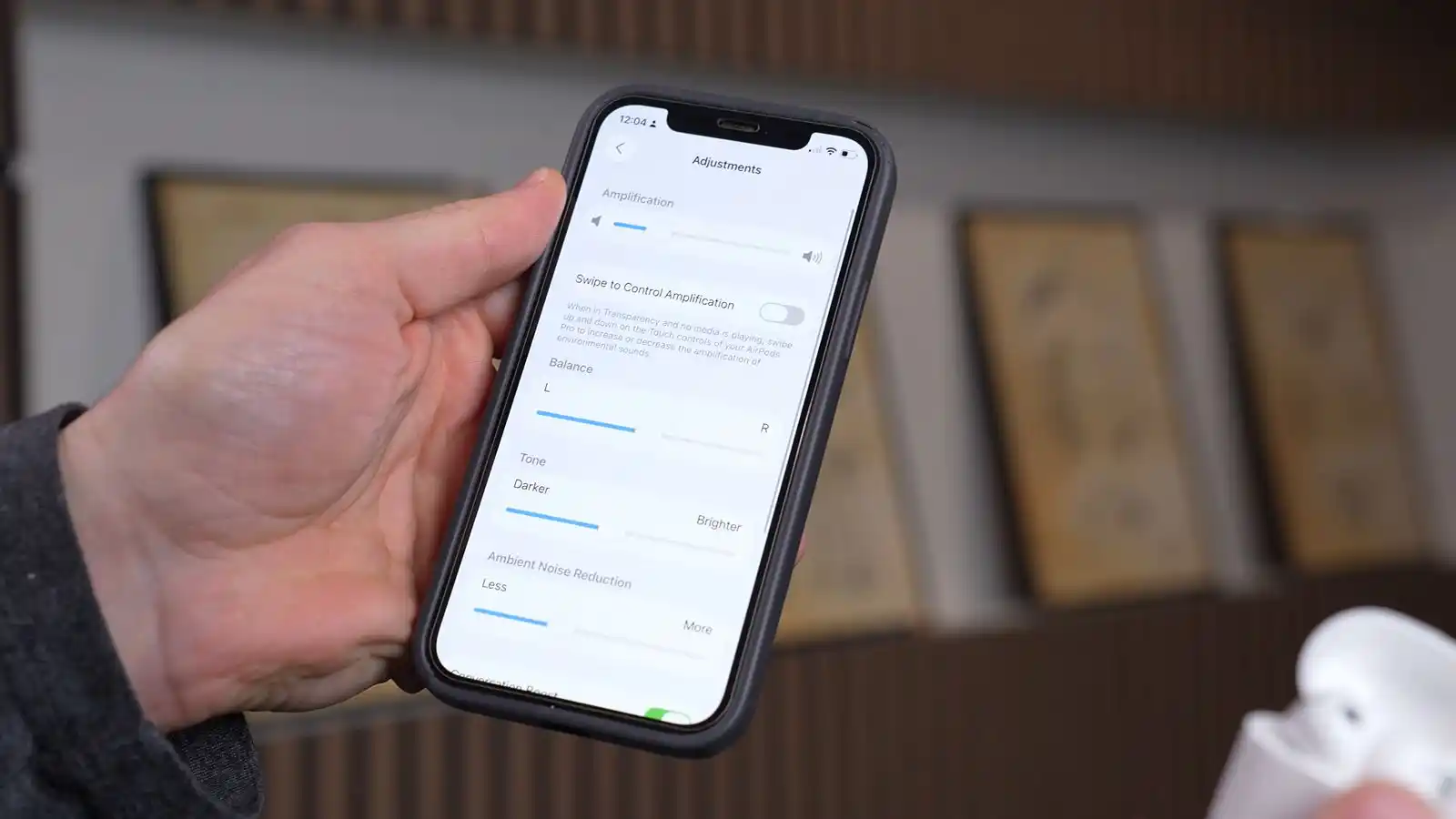 An iPhone showing the AirPods Pro 3 OTC hearing aids adjustments screen.