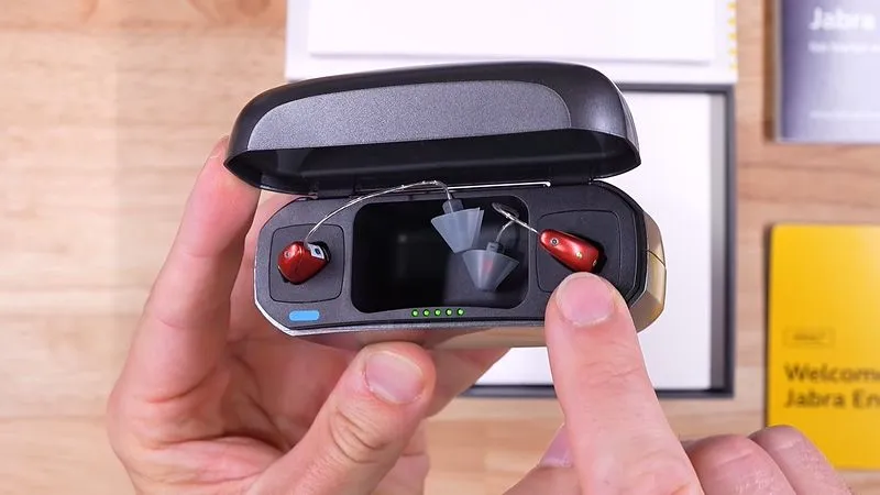 The Jabra Enhance Select 700 hearing aids in their charging case.