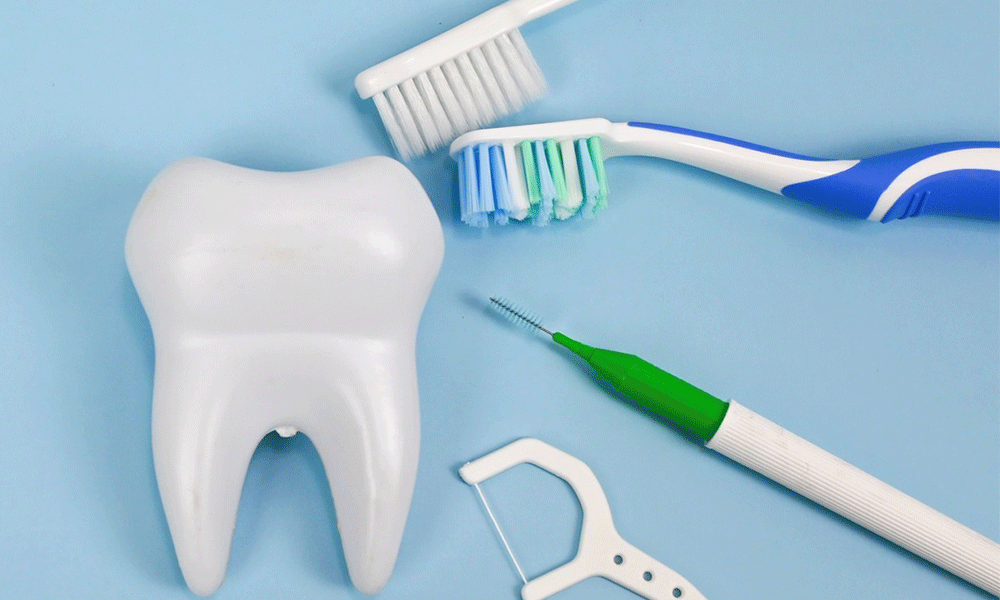 Tooth with toothbrushes, dental floss sticks and interdental brush.