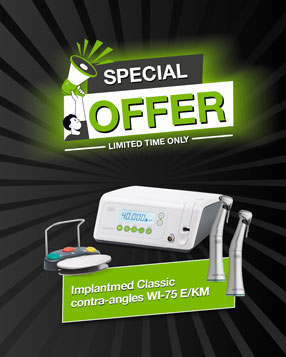 Implantmed Classic with foot control and surgical contra-angle handpieces on green background