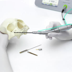 Demonstration of the drill positioning for a zygoma implant in the posterior maxilla, with the Implantmed from W&H in the background.