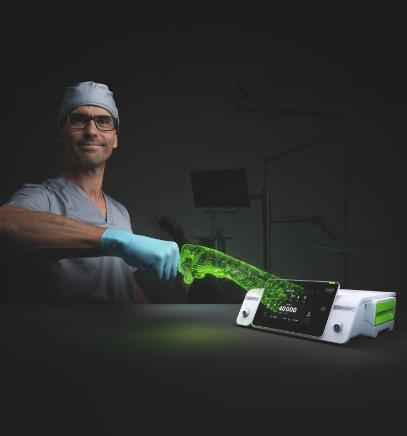 A surgeon with the new Implantmed Plus II and the Piezomed module Plus II in front of a black background.