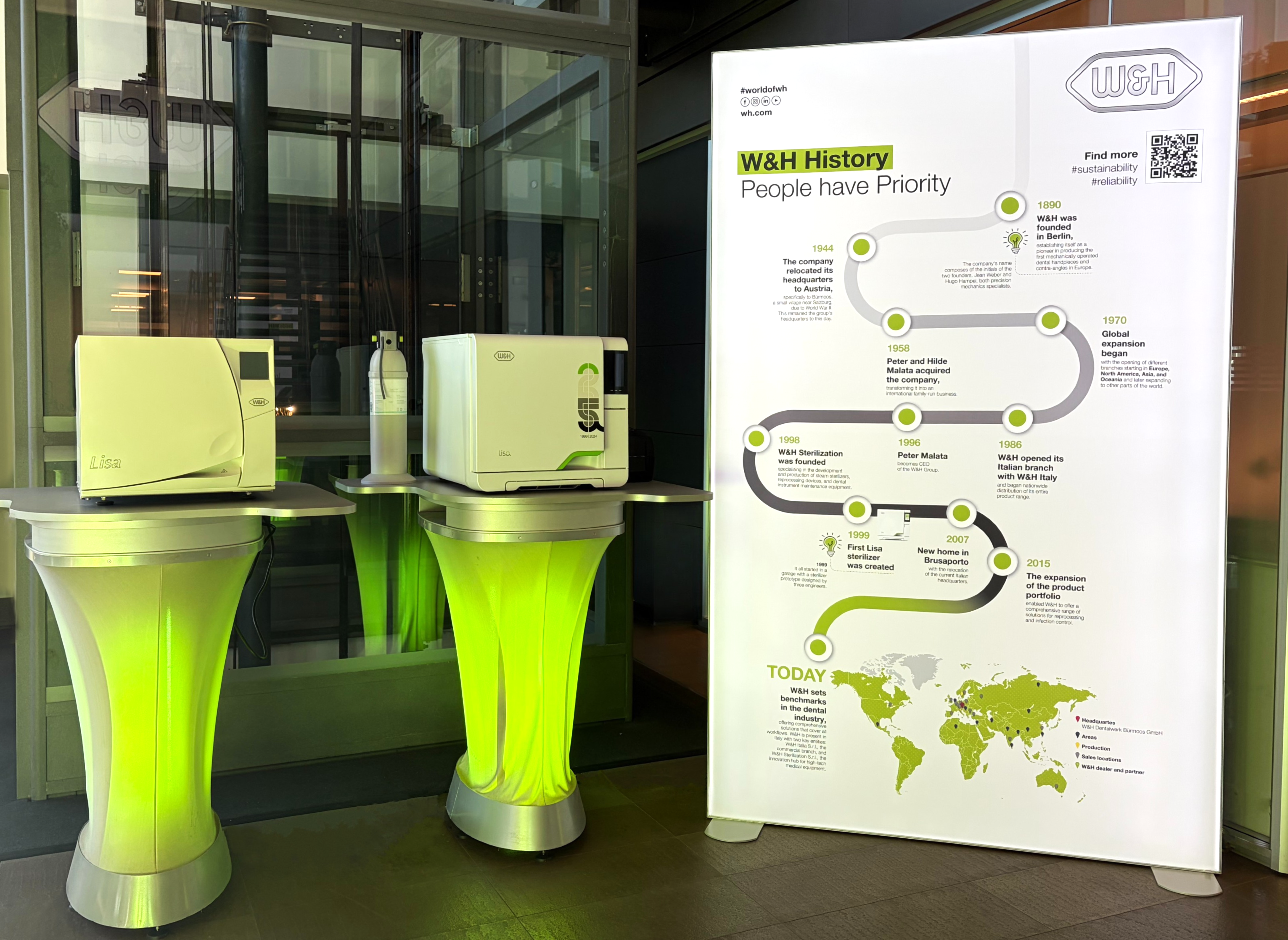Sterilizzatrici W&H e pannello cronologia aziendale esposti nell’ingresso principale.