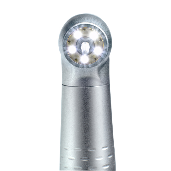 The 5 ×ring LED from W&H, illuminated, in front of a white background.