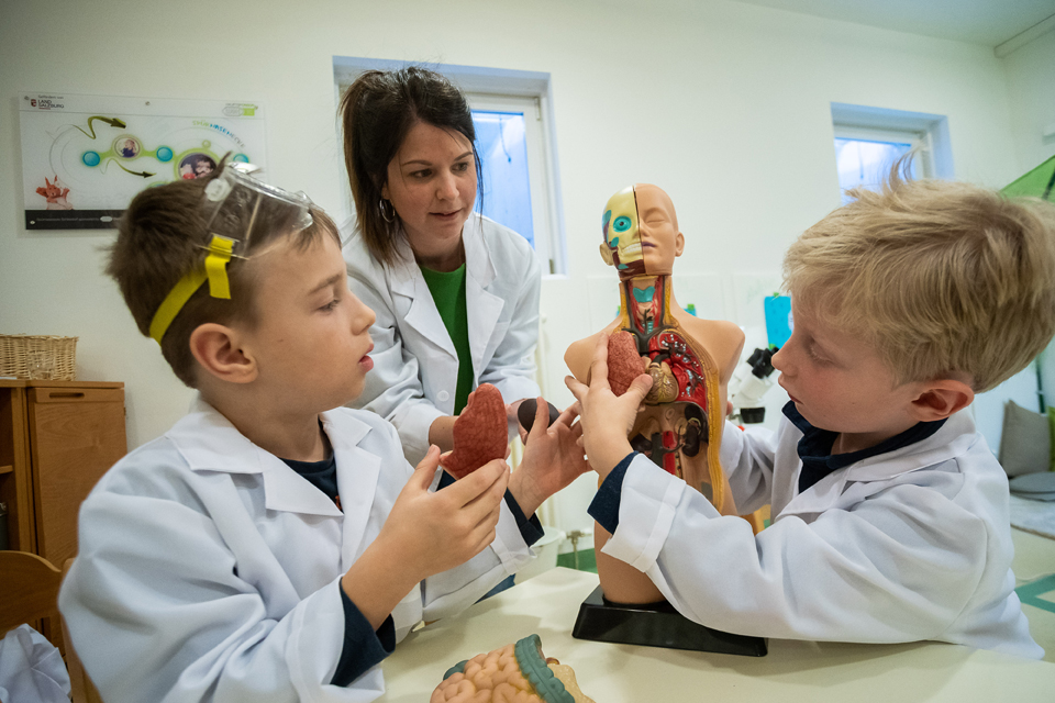 Alexander (li.) und Tobias (re.) erkunden gemeinsam mit Kindergartenpädagogin Christina Grubinger die Anatomie des menschlichen Körpers. Foto: © Chris Hofer