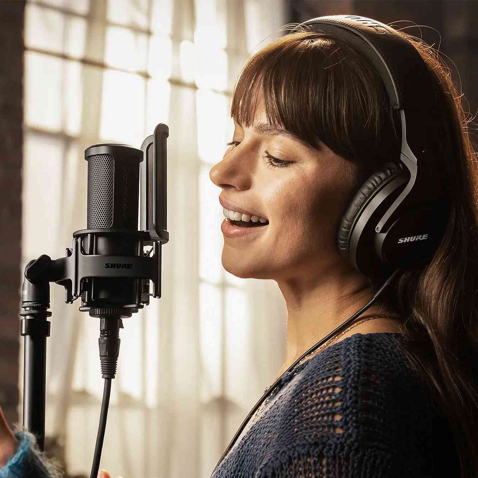 Woman sings into a Shure SM4
