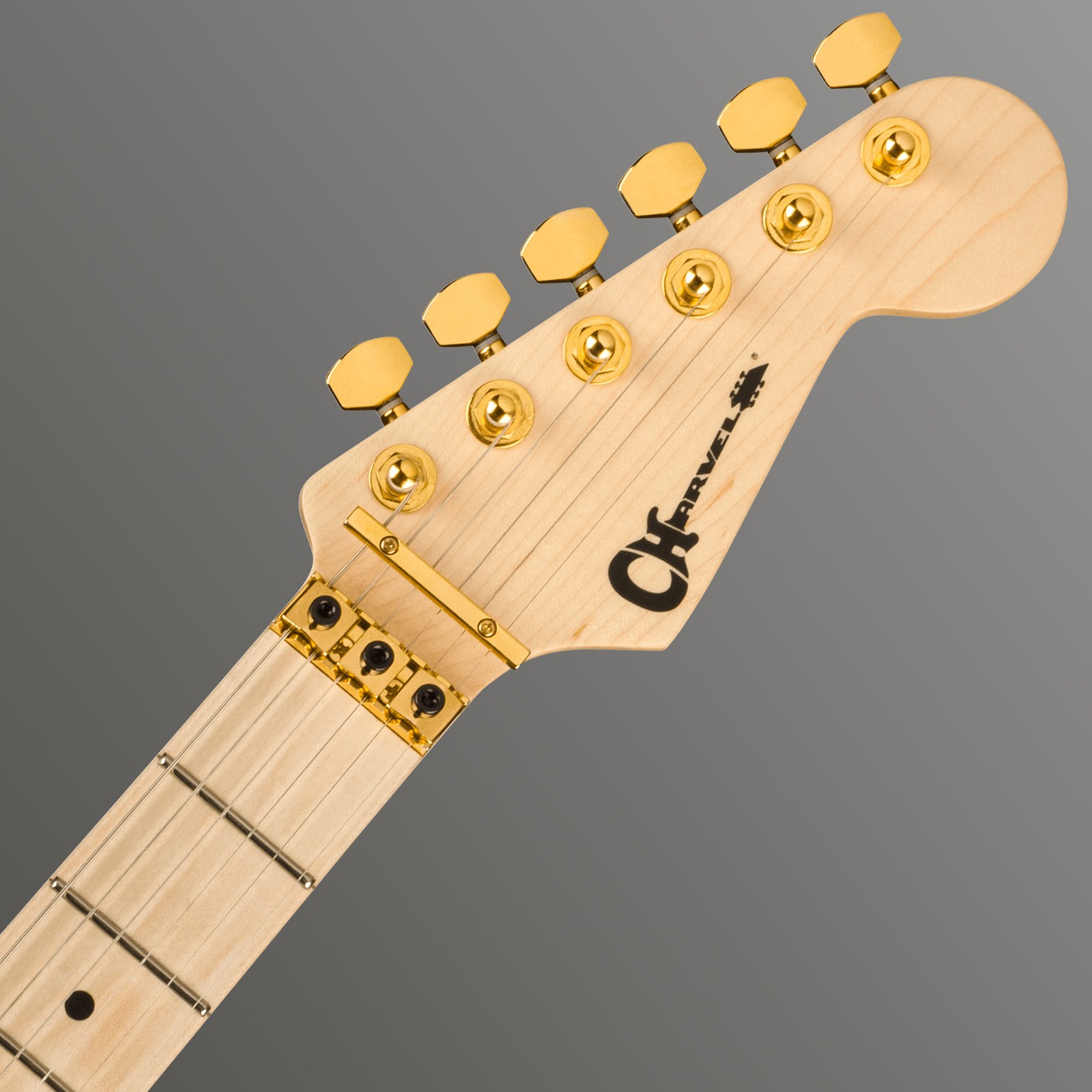 Charvel E-Gitarren Kopfplatte mit goldenen Mechaniken und Klemmsattel
