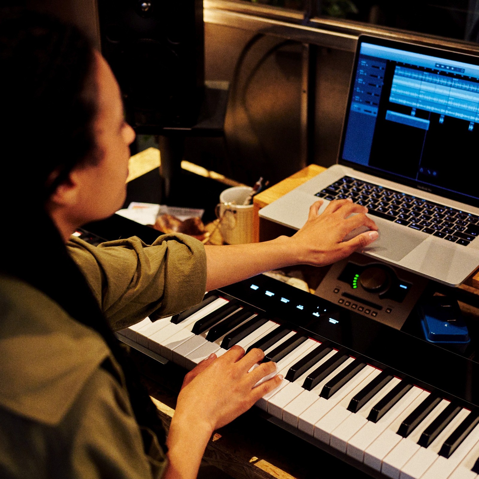 Frau spielt Casio PX-S5000 und macht dabei am Laptop Einstellungen für das Recording