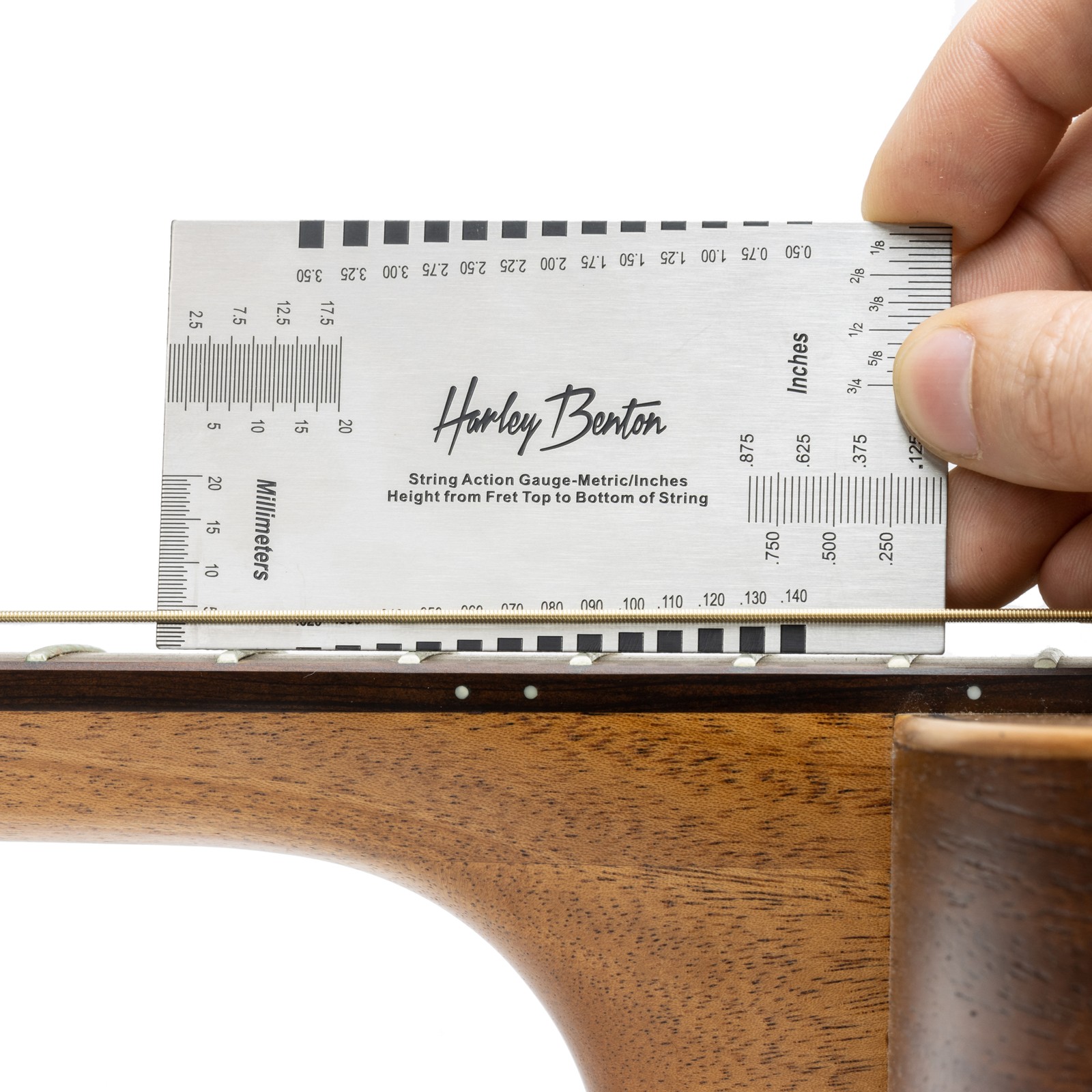 Harley Benton Parts String Action Gauge measuring high string action on an acoustic guitar