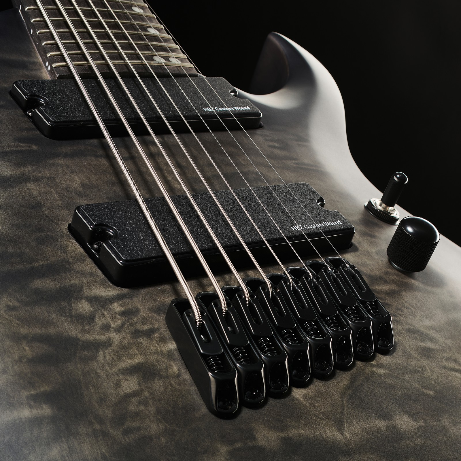 Nahaufnahme von Steg und Tonabnehmer der 8-Saiter Harley Benton MultiScale-8 QBB E-Gitarre