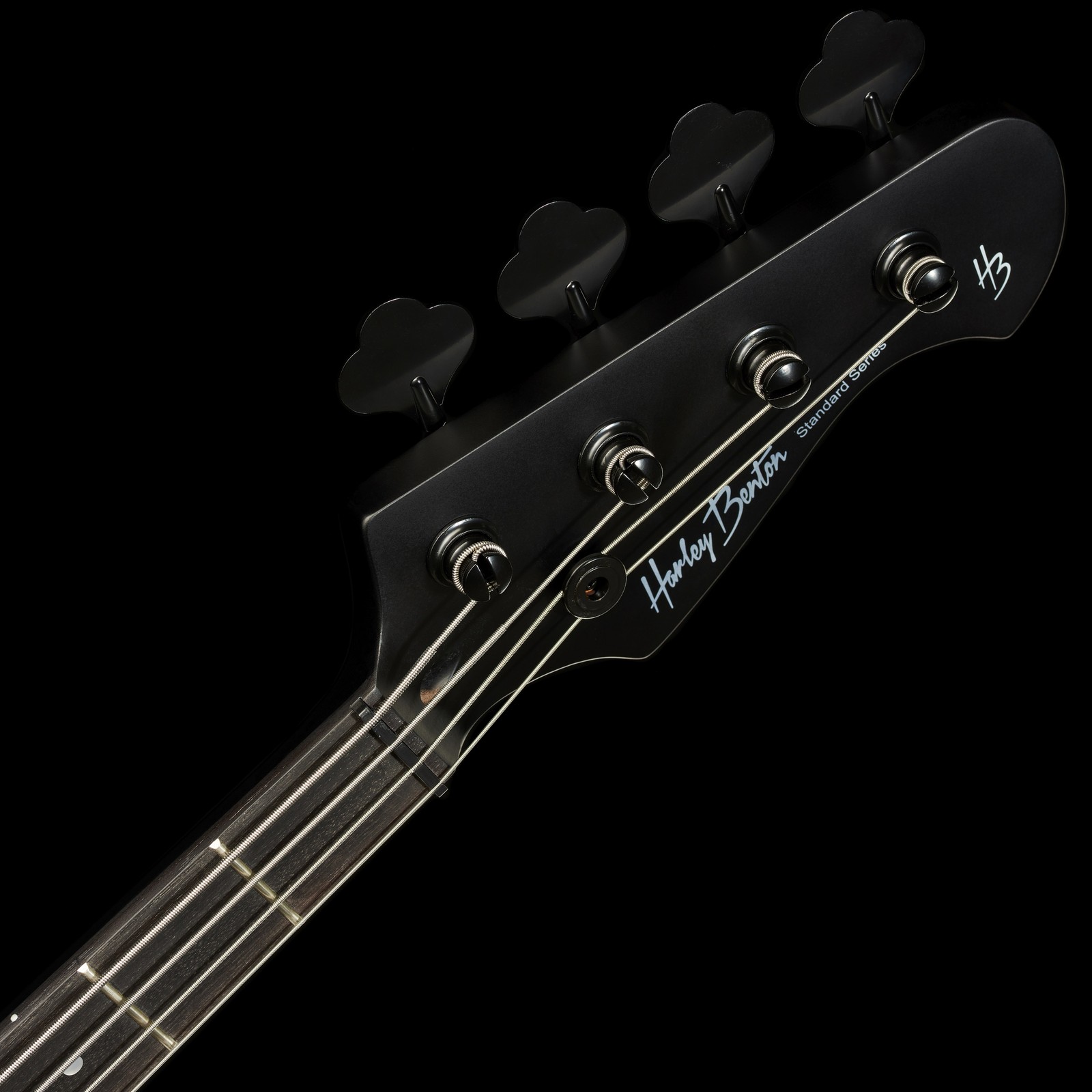 black headstock and fretboard of a four string bass