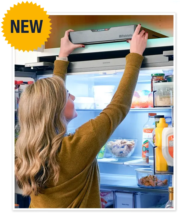 Woman placing Blackout Buddy on top of fridge cabinet
