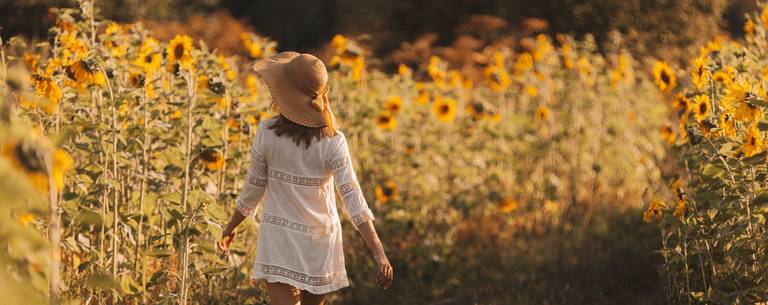 Femme dans un champ de tournesols